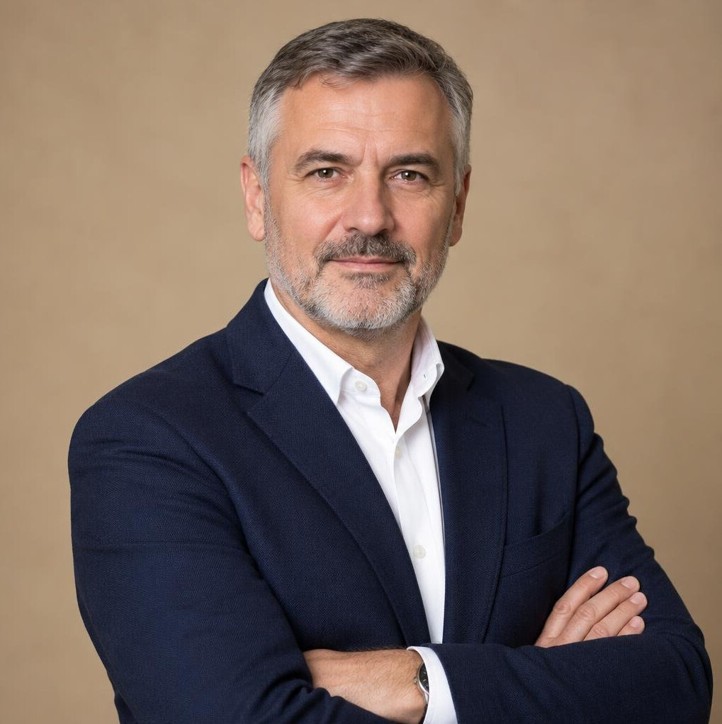 Studio portrait of a middle-aged Croatian male writer in a dark blazer
