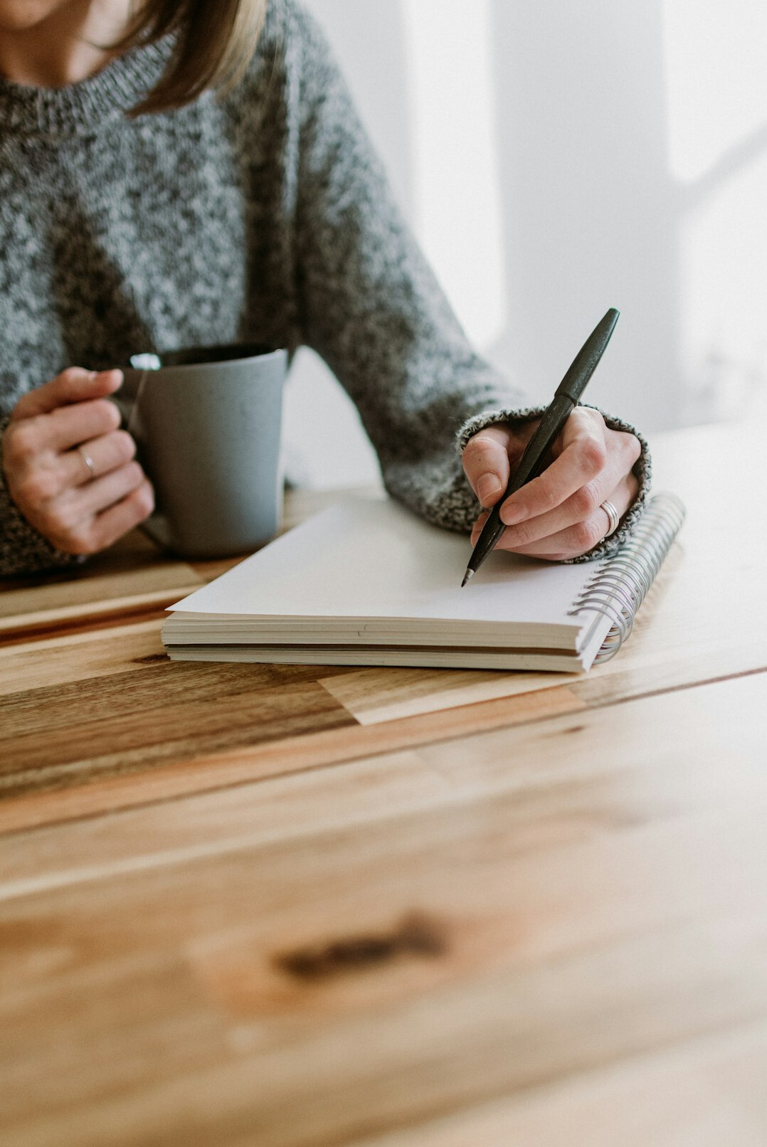 author writing in notebook